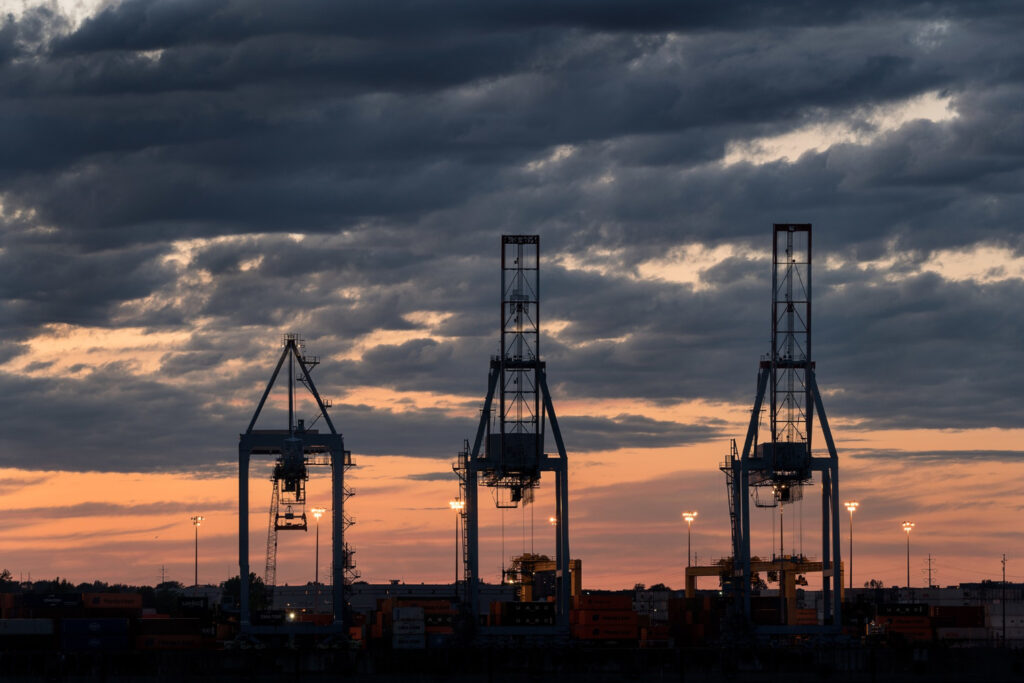 US port cranes at sunset tariff volatility 2026 export impact
