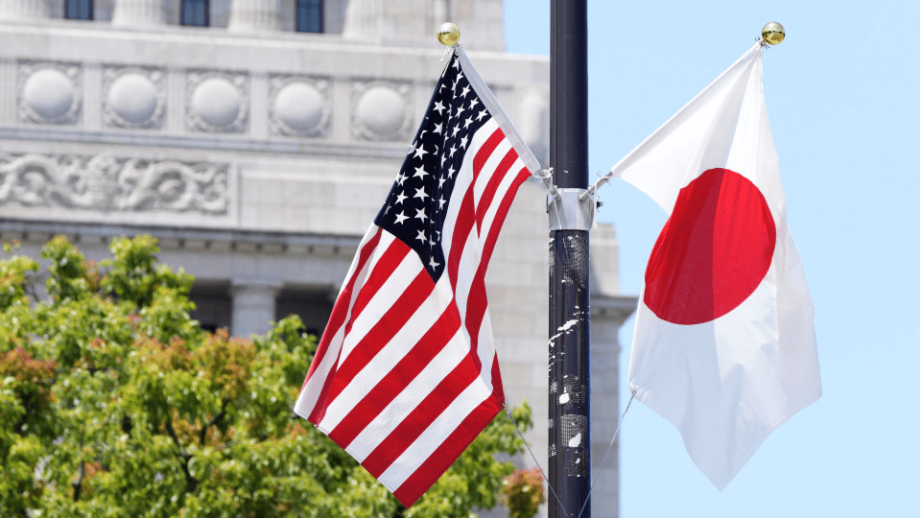 US-Japan trade logistics - American and Japanese flags outside government building